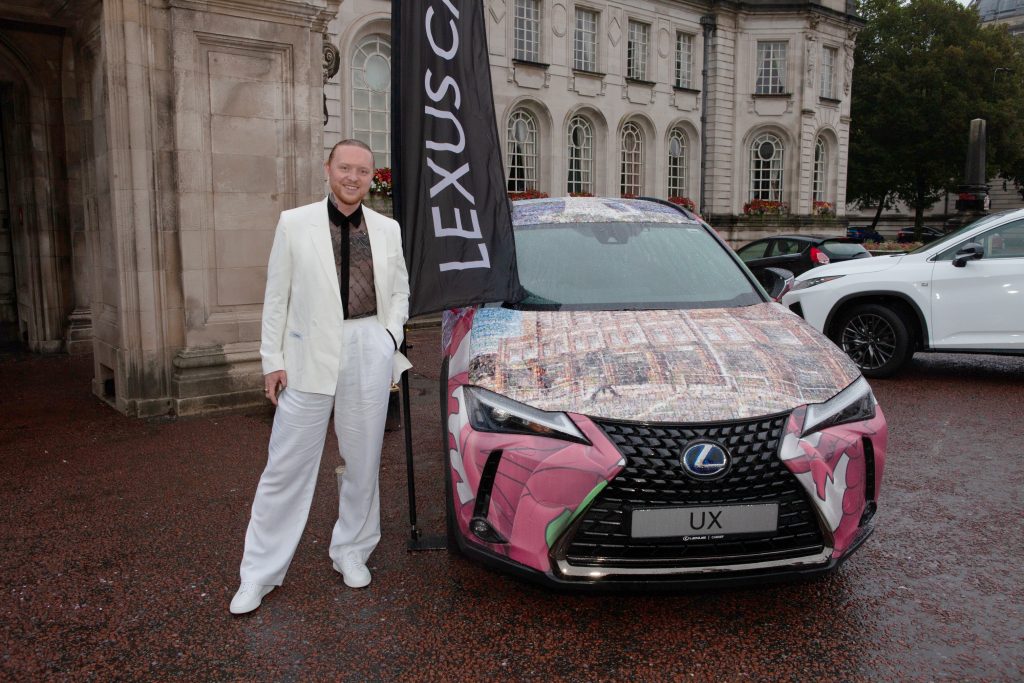 Artist Nathan Wyburn with his Cardiff-inspired artwork wrapped onto a Lexus UX hybrid SUV