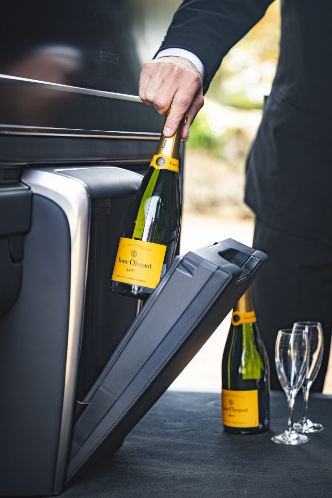 Chauffeur Rob Mitchelmore stocks the Lexus LM before the passengers arrive